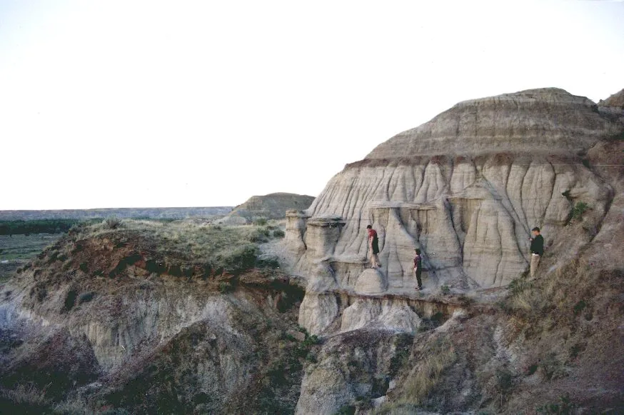 A single hoodoo with a hard capstone balanced on a narrow column of eroded sandstone in the Alberta badlands