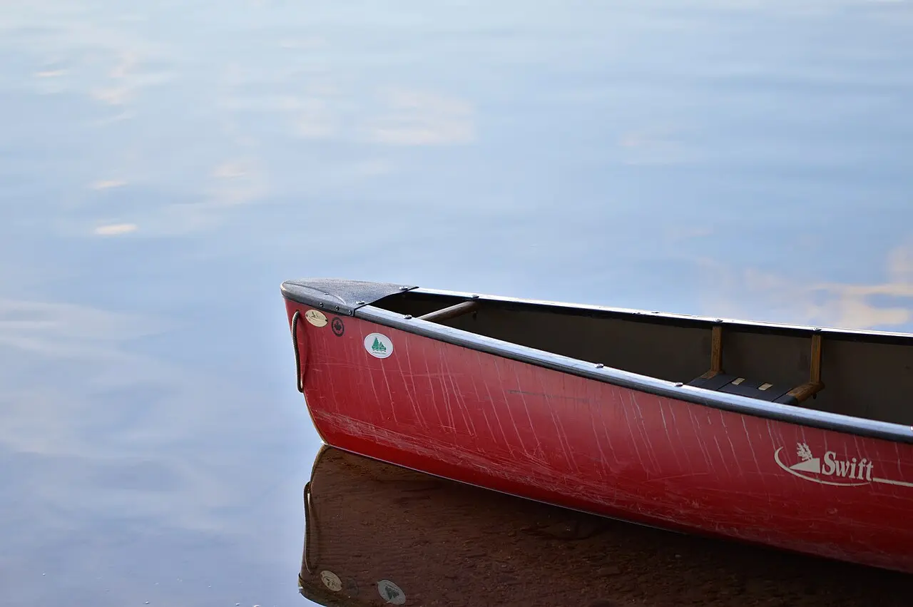 Empty canoe pulled up on a rocky Algonquin lakeshore