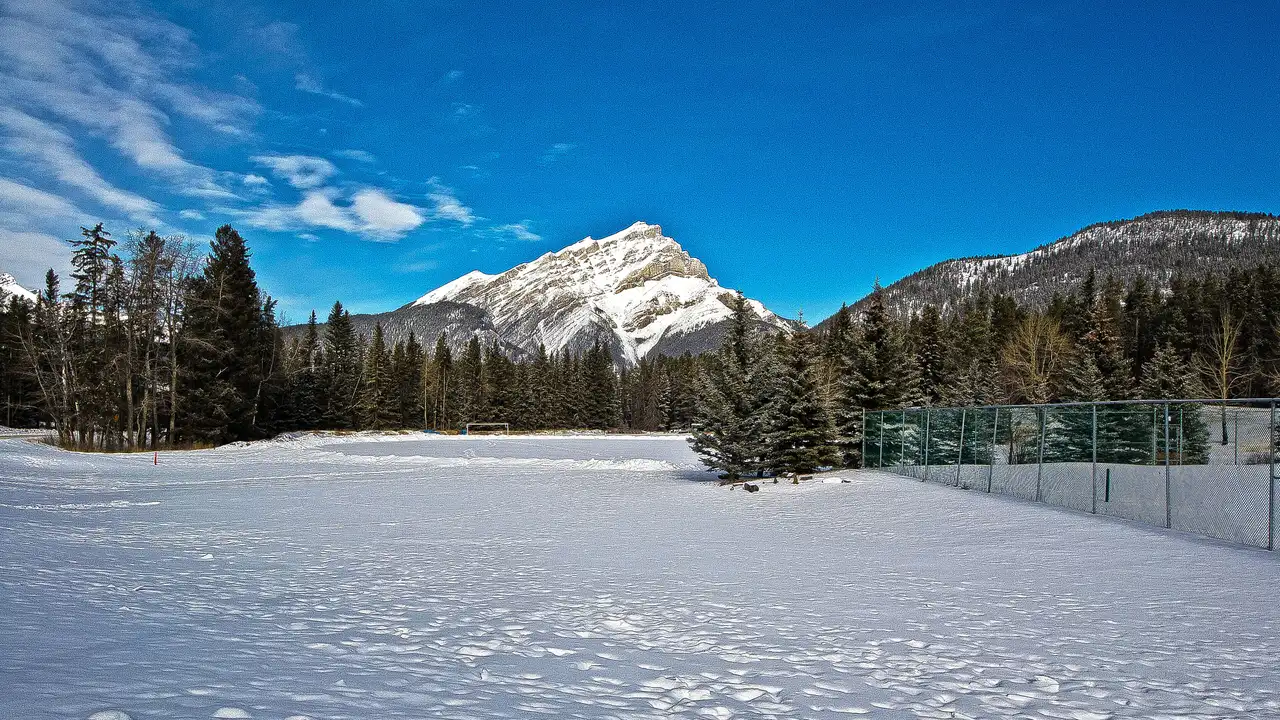 Cascade Mountain rising over the snow-covered rooftops of the town of Banff on a clear winter day