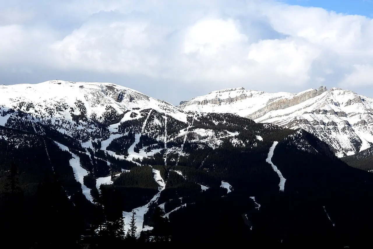 Cross-country ski trails cut across deep snow with the Chateau Lake Louise and forested slopes behind