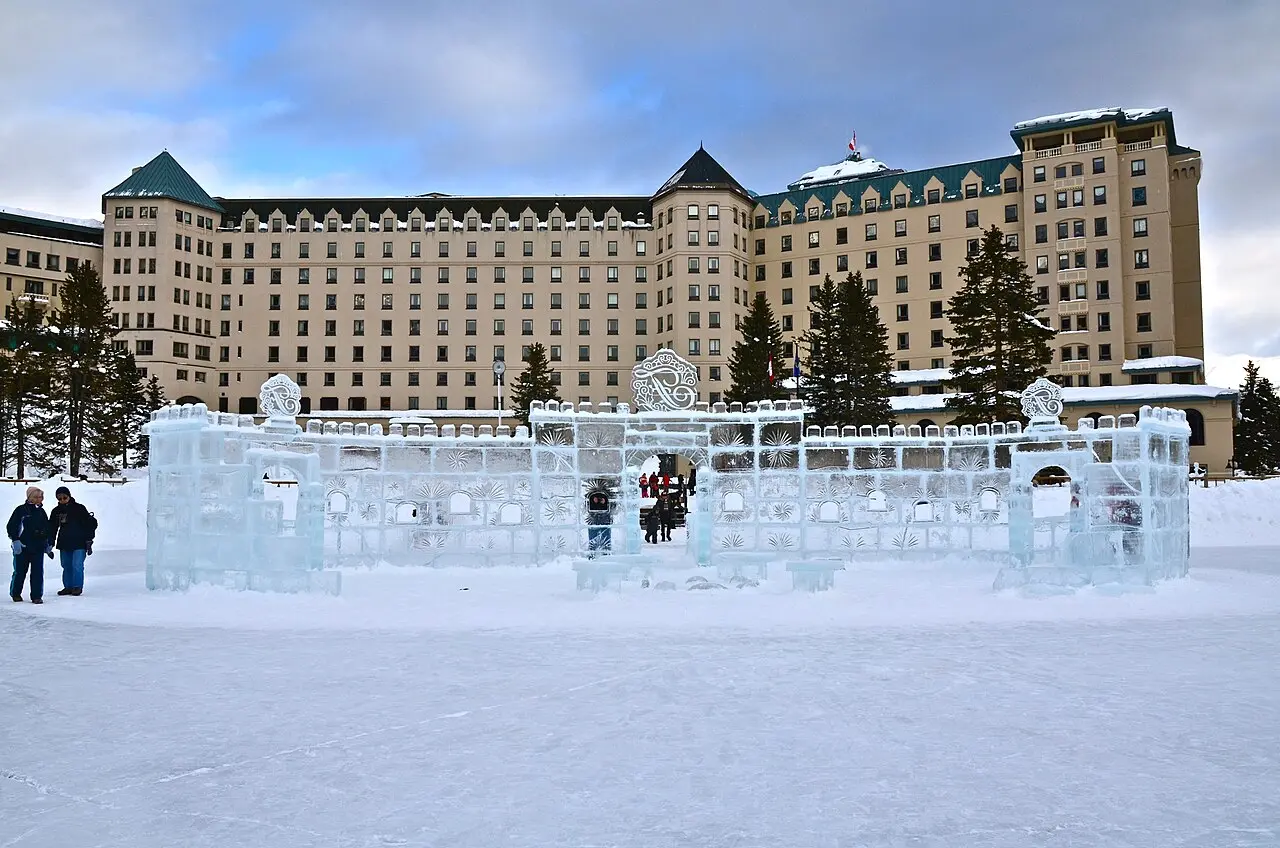 An ice castle built on the frozen surface of Lake Louise in front of the Fairmont Chateau hotel