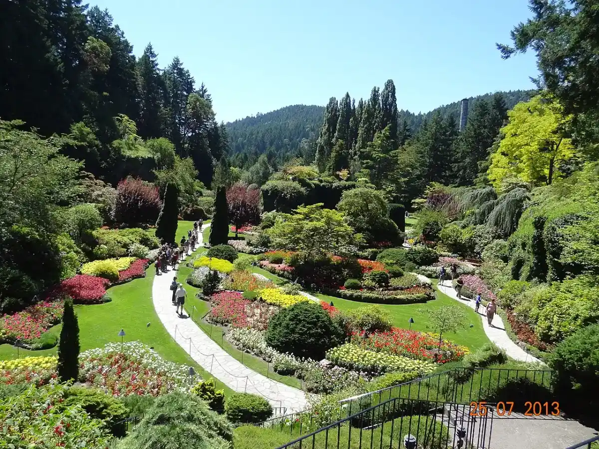 Dense flower beds and stone paths in the Sunken Garden at The Butchart Gardens, a former limestone quarry