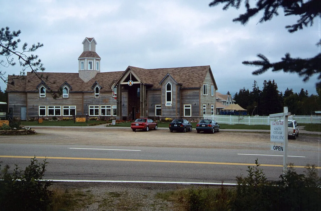 The timber Gaelic College craft shop building with a cupola beside the road at St. Ann's