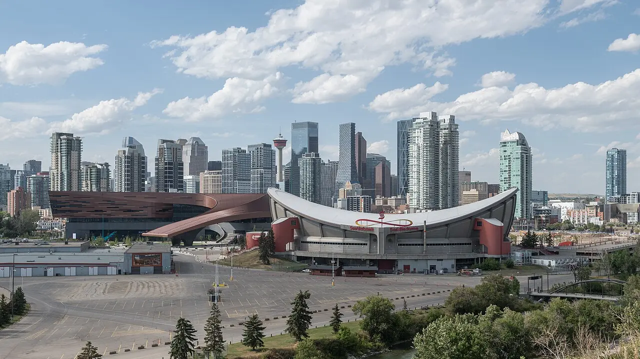 Stampede Park grounds with the Calgary skyline rising behind empty grandstands and parking lots