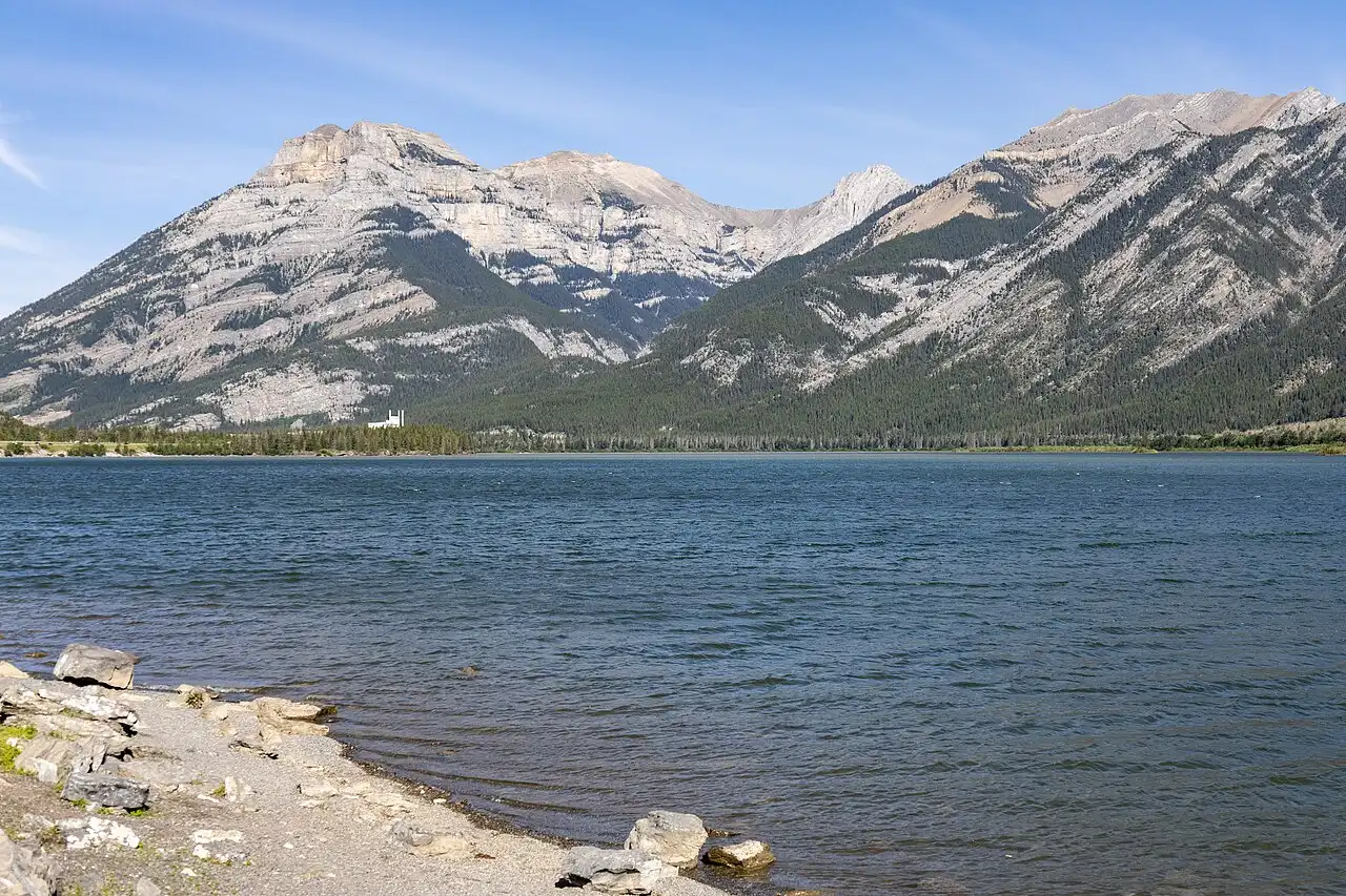 Lac des Arcs near Canmore with mountain ridges reflected in still water