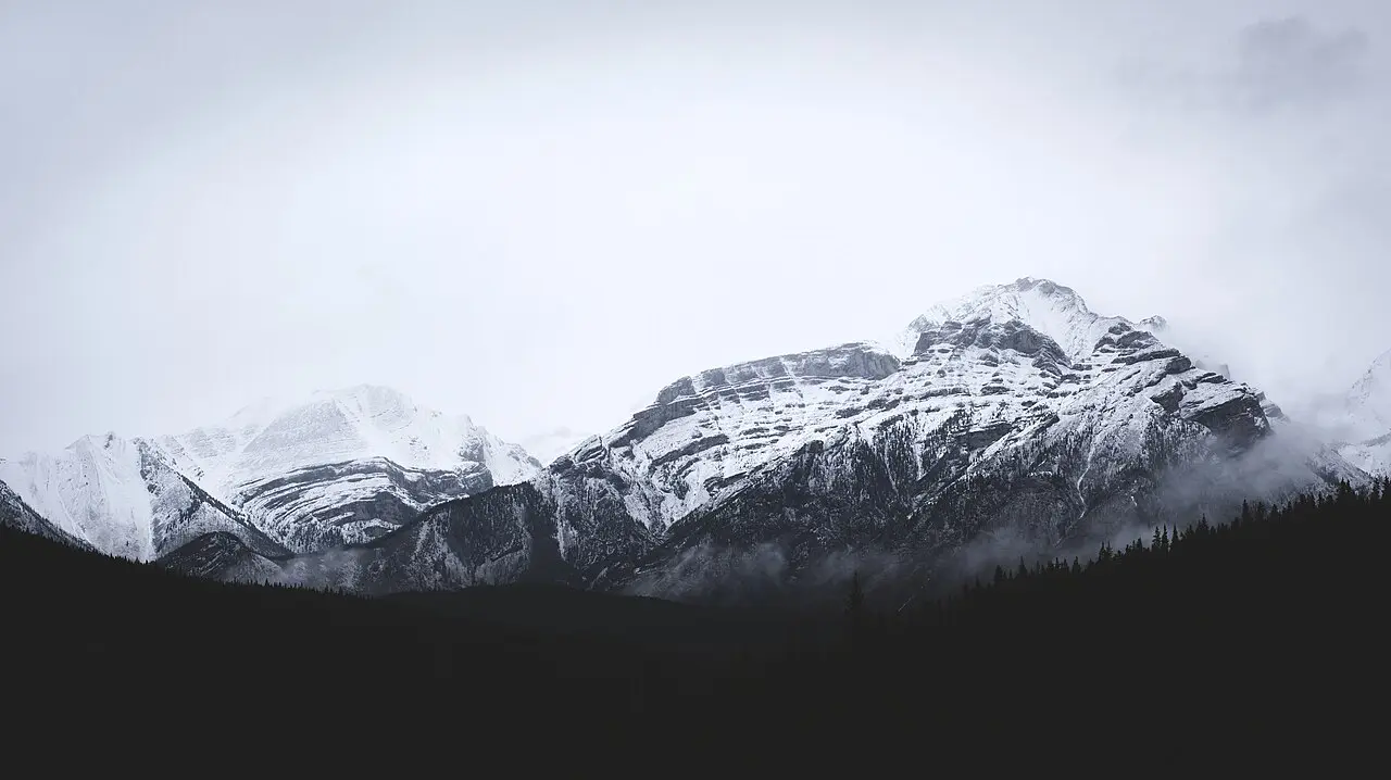 Banff Avenue under low cloud with Cascade Mountain rising at the end of the street