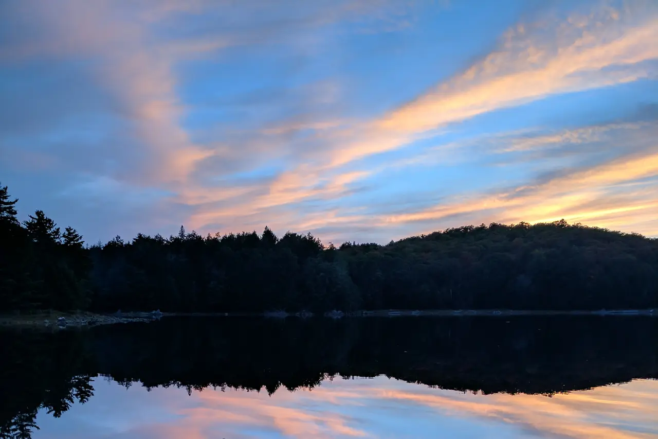 Sunset over Ragged Lake in Algonquin Provincial Park with forest on the far shore