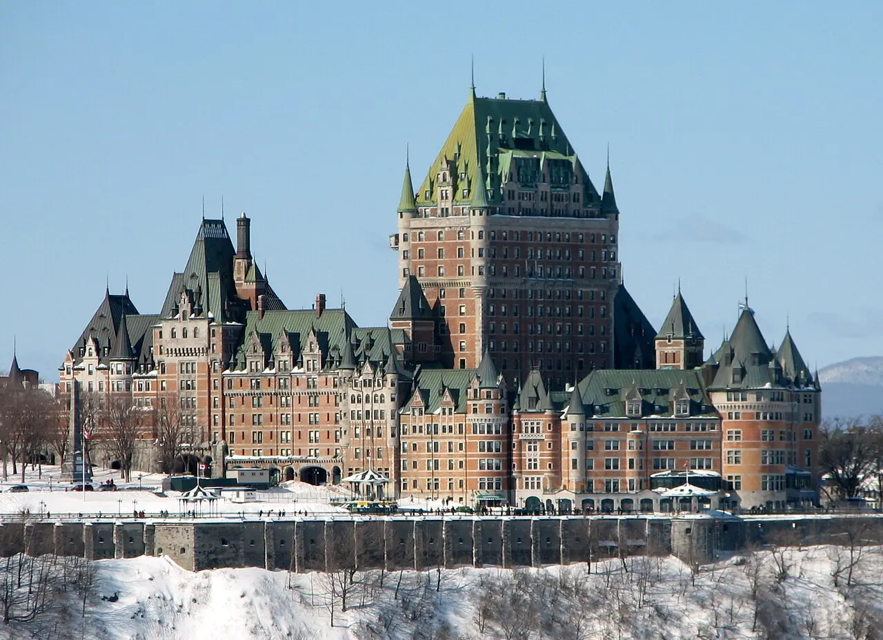 The Chateau Frontenac hotel rising above the rooftops of old Quebec City above the St Lawrence