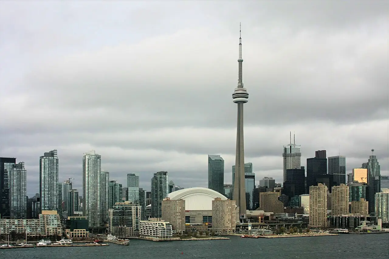 The Toronto waterfront with sailing boats on Lake Ontario and the CN Tower rising over the downtown towers