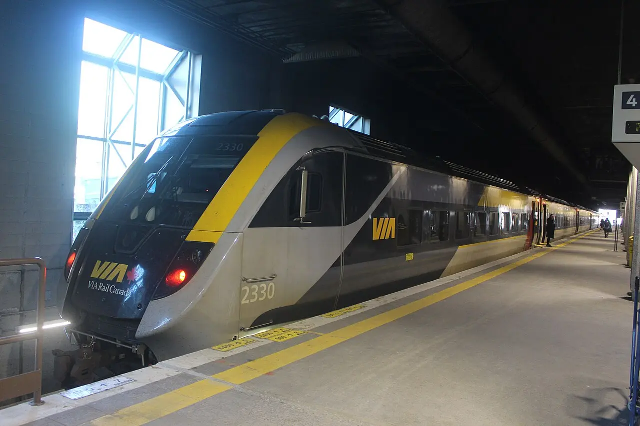 A VIA Rail Corridor train with a Siemens locomotive standing at a station platform