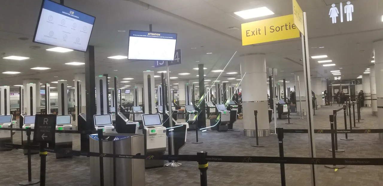 The customs and immigration arrivals area at Toronto Pearson Terminal 3, with signage directing arriving passengers
