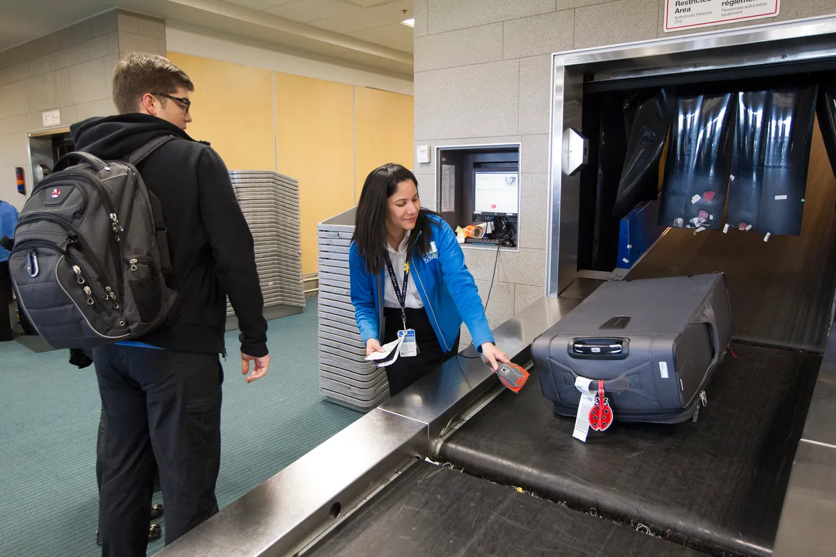 Travellers passing through a US Customs and Border Protection preclearance hall inside a Canadian airport