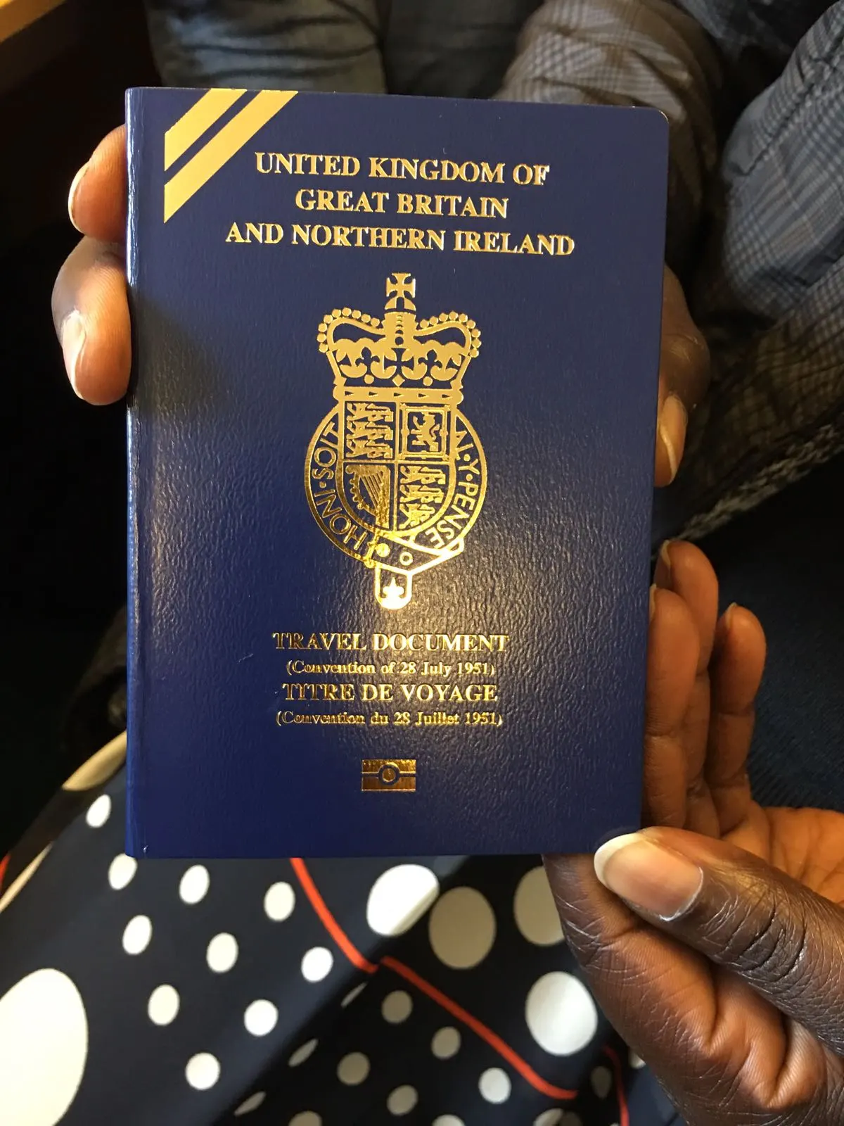 A burgundy British passport closed on a wooden surface
