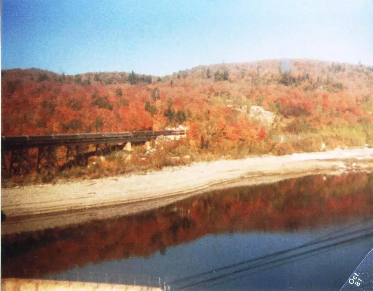 The Agawa Canyon tour train on the canyon floor surrounded by autumn forest in northern Ontario