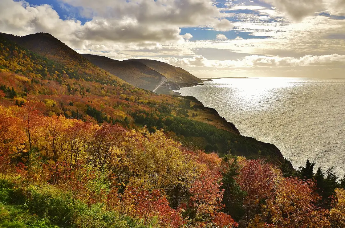 Autumn colour on the forested hills above the coastline of the Cabot Trail in Cape Breton
