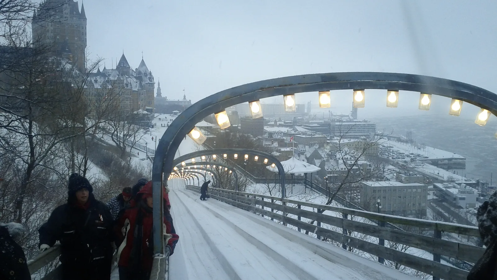The lit toboggan run on Terrasse Dufferin in Quebec City with the snow-covered Chateau Frontenac above it