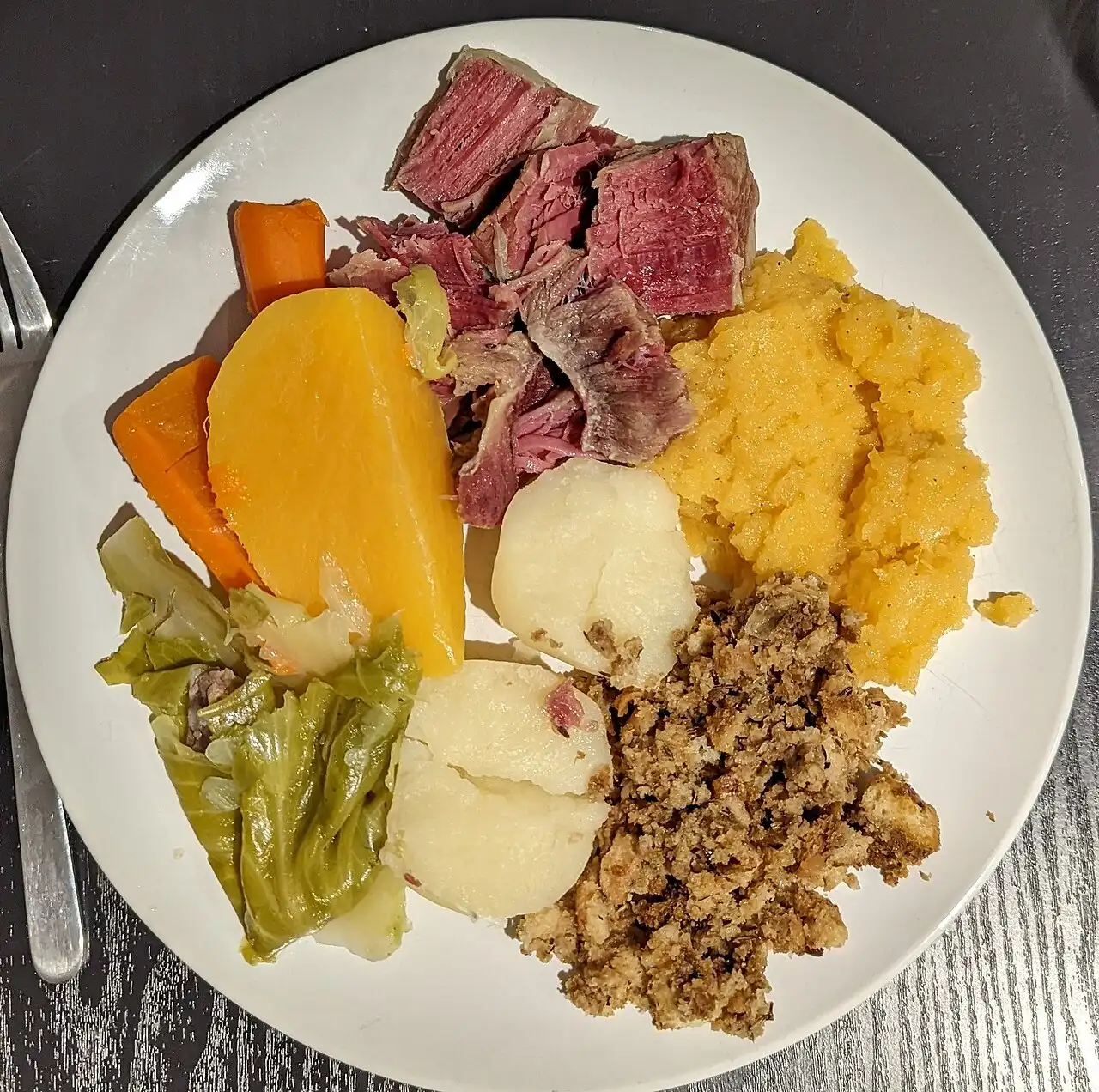 A plate of Jiggs' dinner with salt meat, cabbage, turnip, carrot and potato