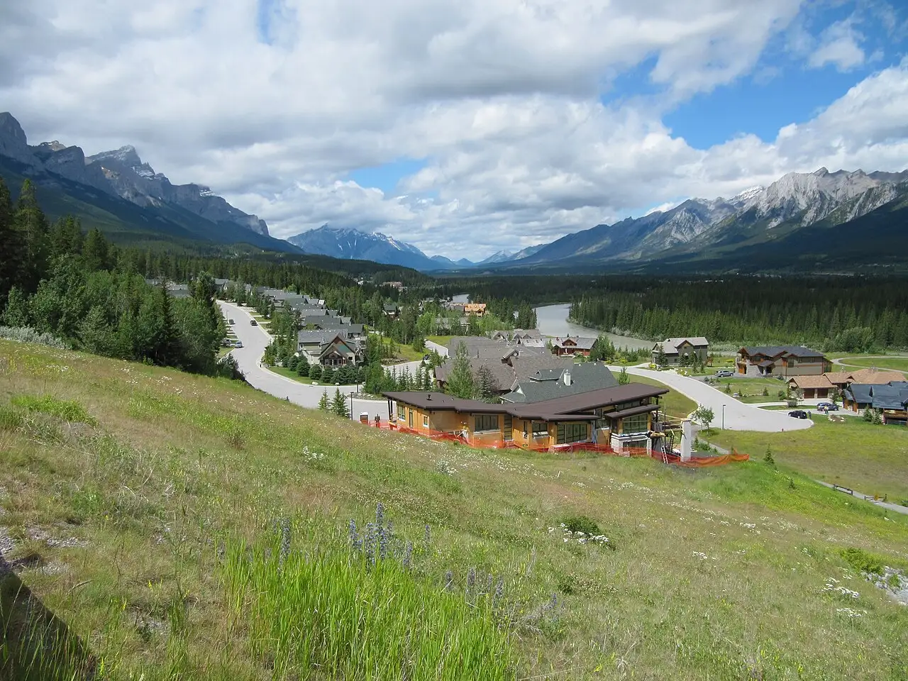 Bow Valley forest and distant peaks seen from the Three Sisters Parkway near Canmore