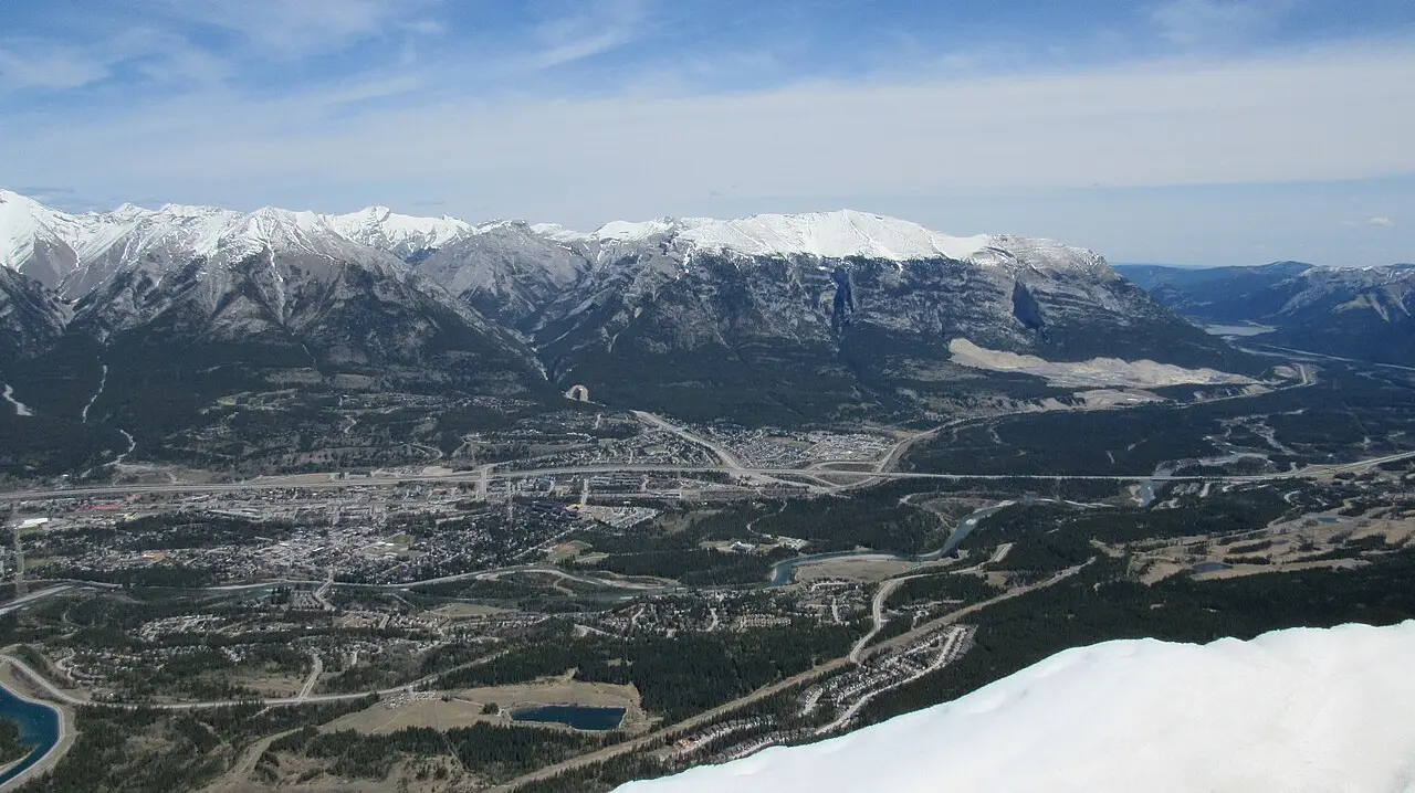 Canmore townsite and the Fairholme Range seen from high on Ha Ling Peak under a clear sky