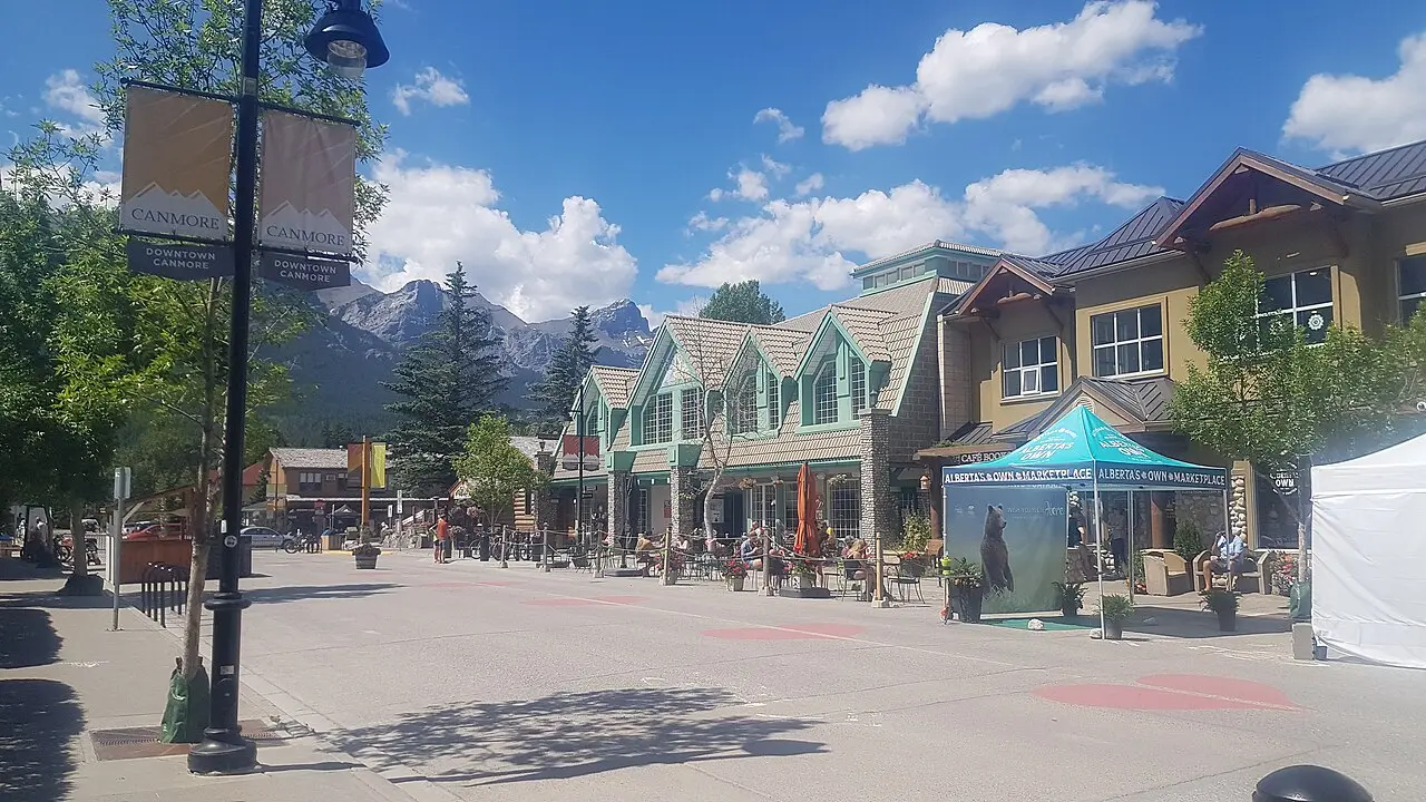 Downtown Canmore street with mountain ridges filling the end of the block