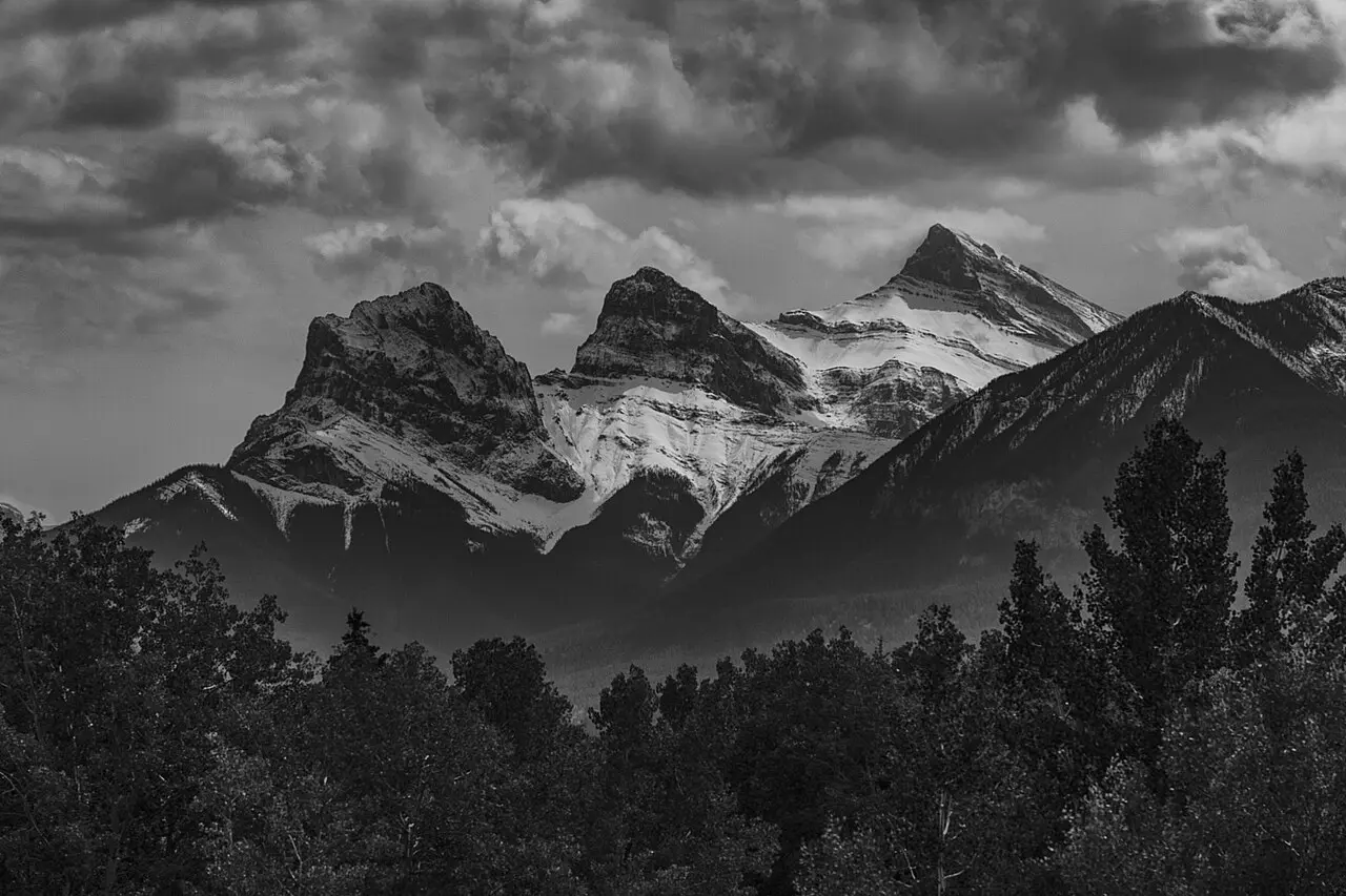 The Three Sisters peaks rising above Canmore under a clear Alberta sky