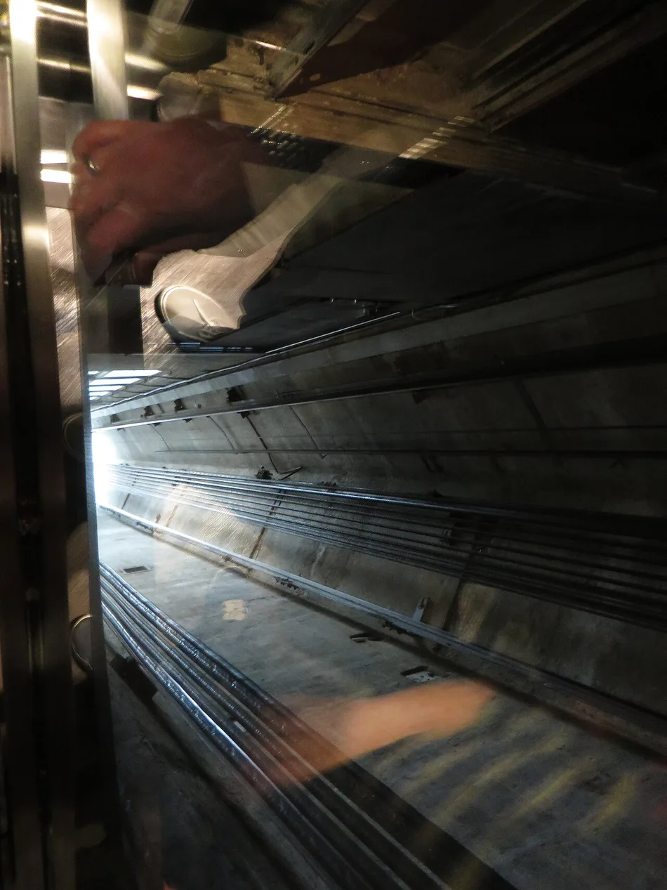 Interior view looking up inside one of the CN Tower's glass-fronted elevators during the ride to the observation level
