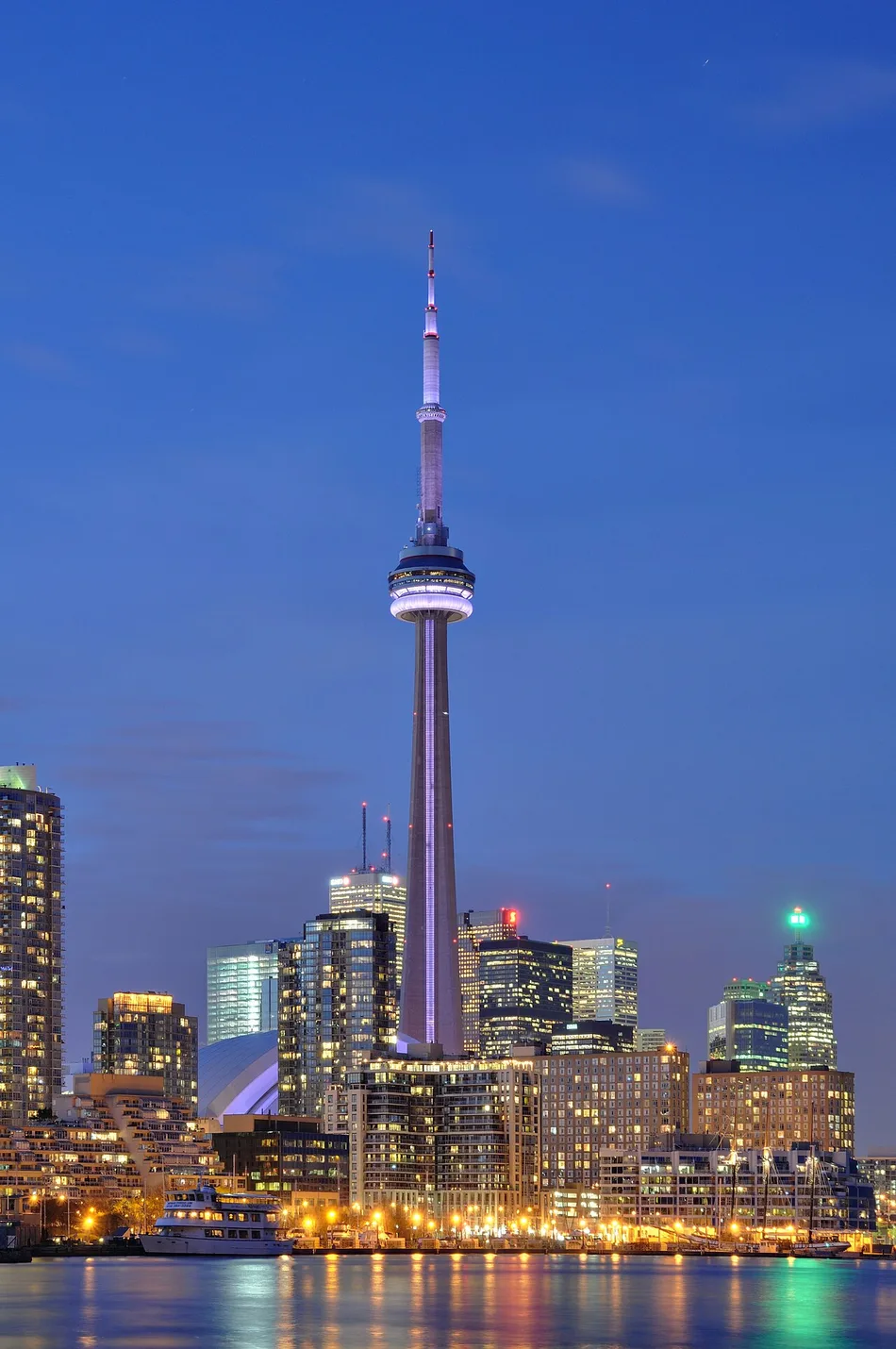 The illuminated CN Tower rising over downtown Toronto after dark