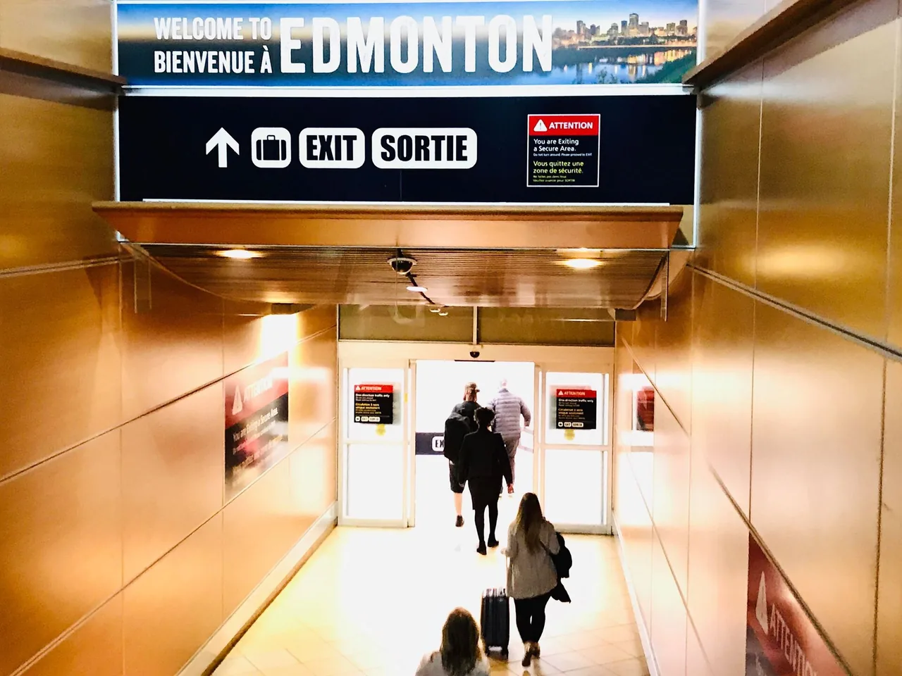 Passengers with luggage outside Edmonton International Airport