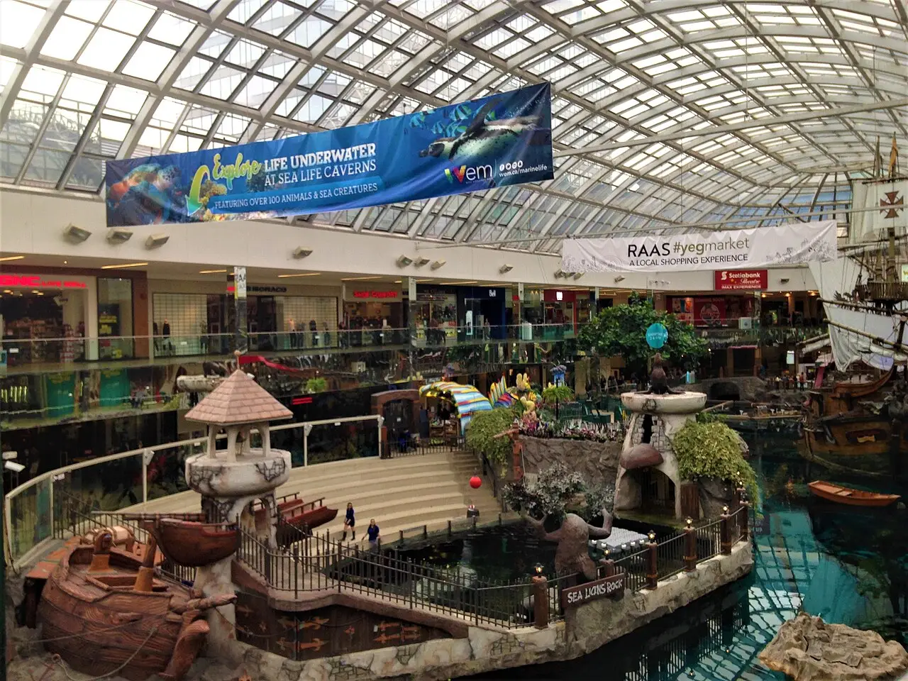 The indoor lake at West Edmonton Mall Phase 3 with a replica sailing ship moored beside shopfronts