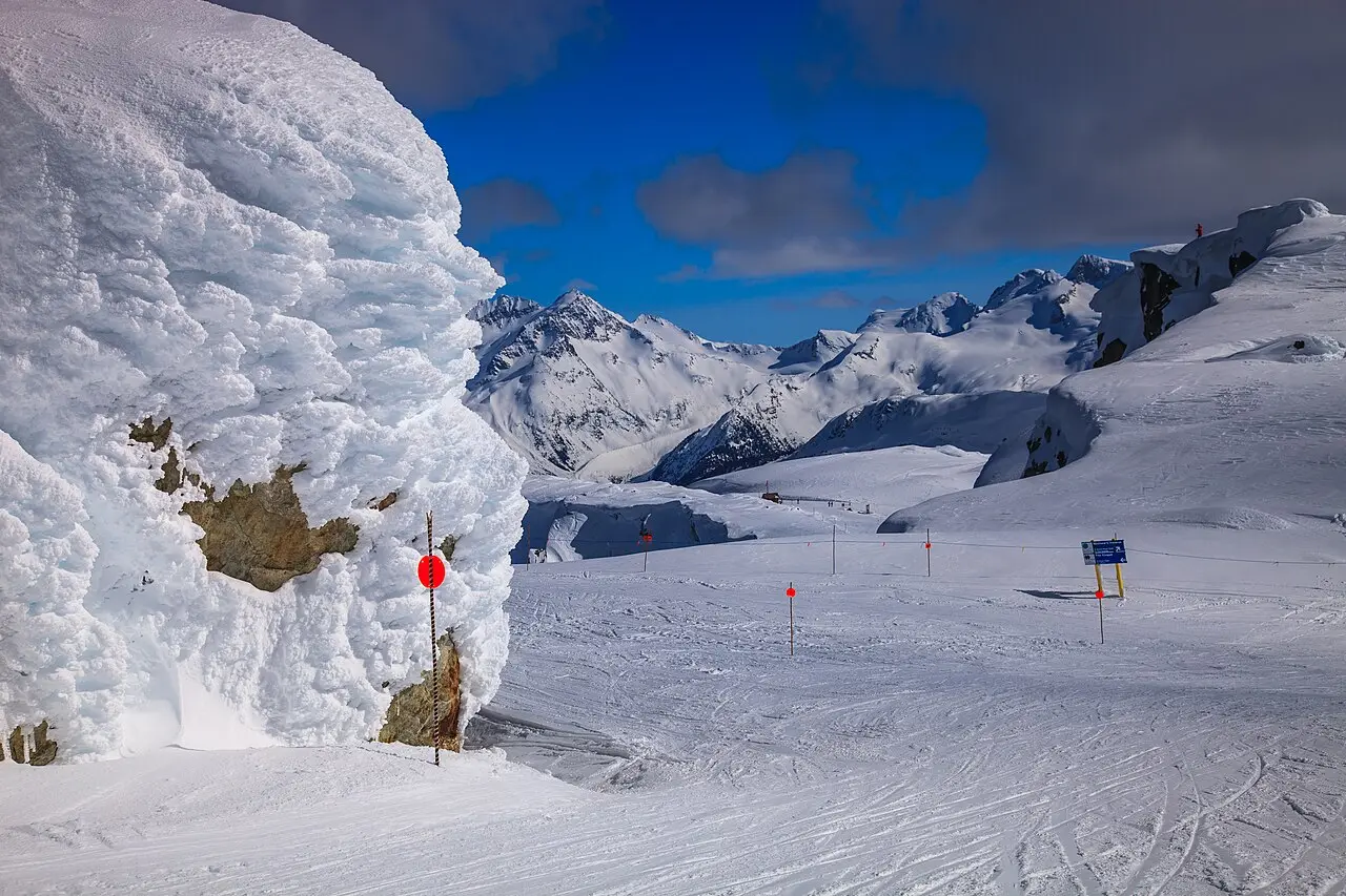 Clear-day alpine skiing on Whistler Mountain with marked runs and forested ridges