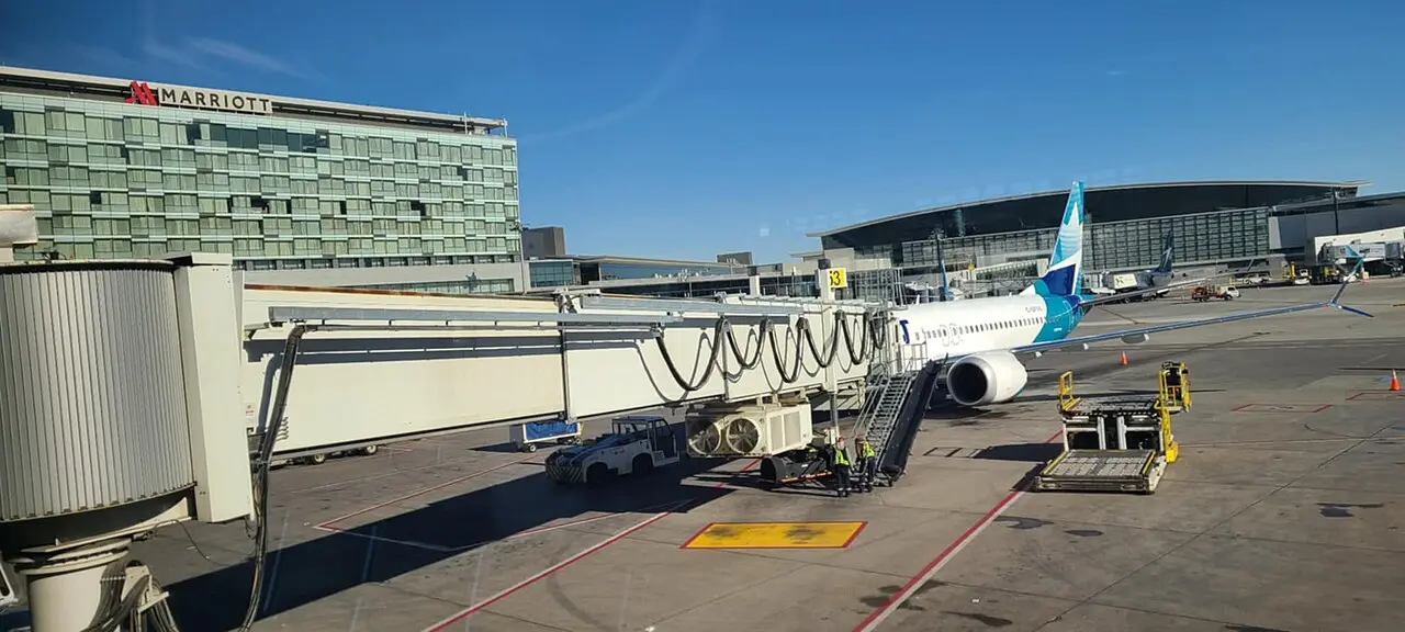 An aircraft parked at a jet bridge at Calgary International Airport