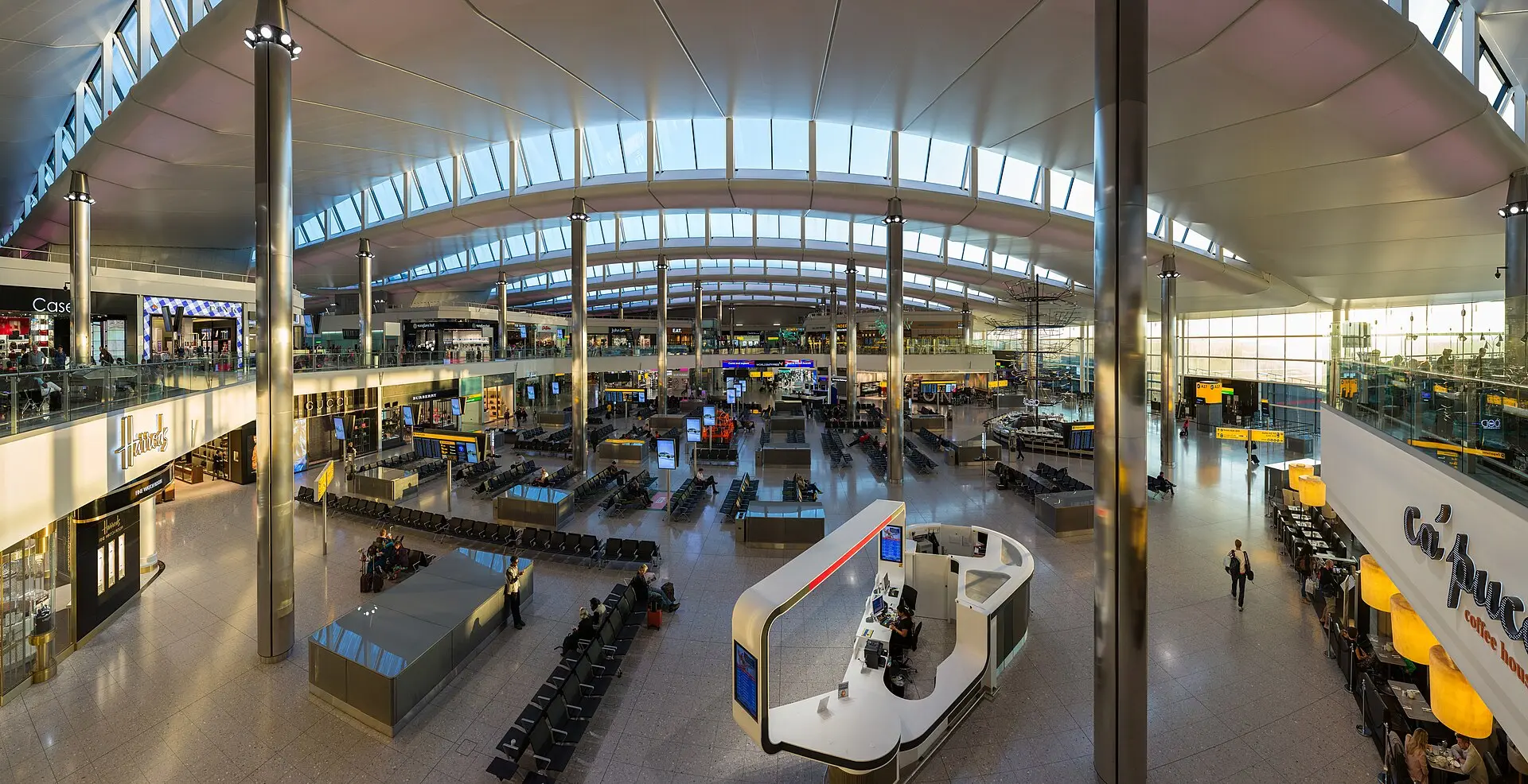 Exterior of Heathrow Airport Terminal 2 under a partly cloudy sky