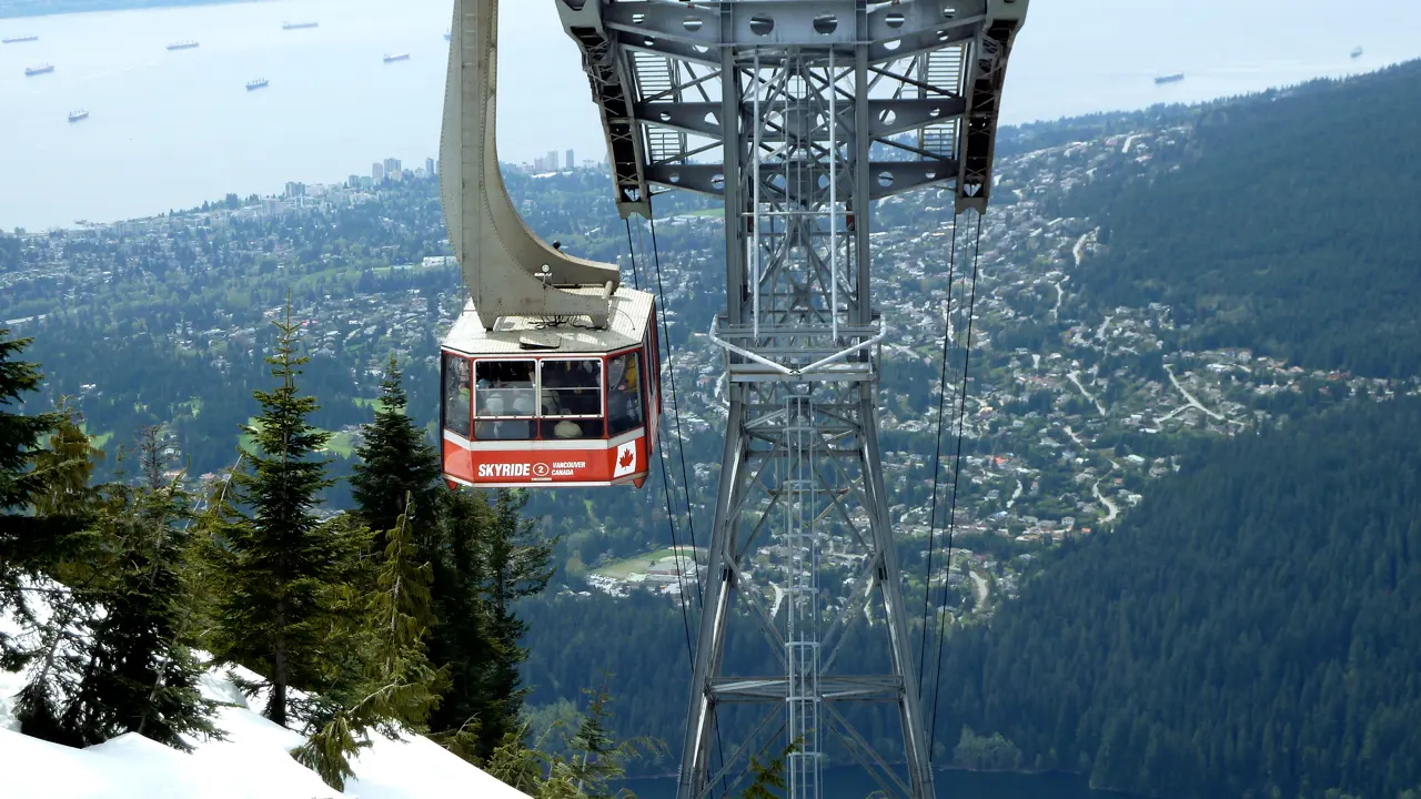 The red Grouse Mountain Skyride cabin on its cables above the North Shore forest
