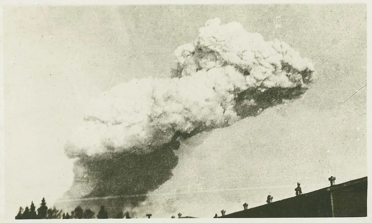A vintage 1917 photograph of the huge smoke cloud rising over Halifax from the explosion, seen above rooftops