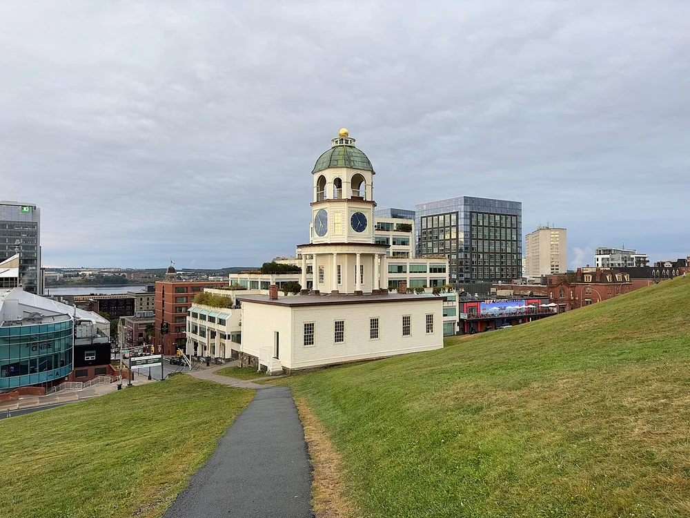 The white Old Town Clock with its green dome on the grassy slope of Citadel Hill above downtown Halifax and the harbour