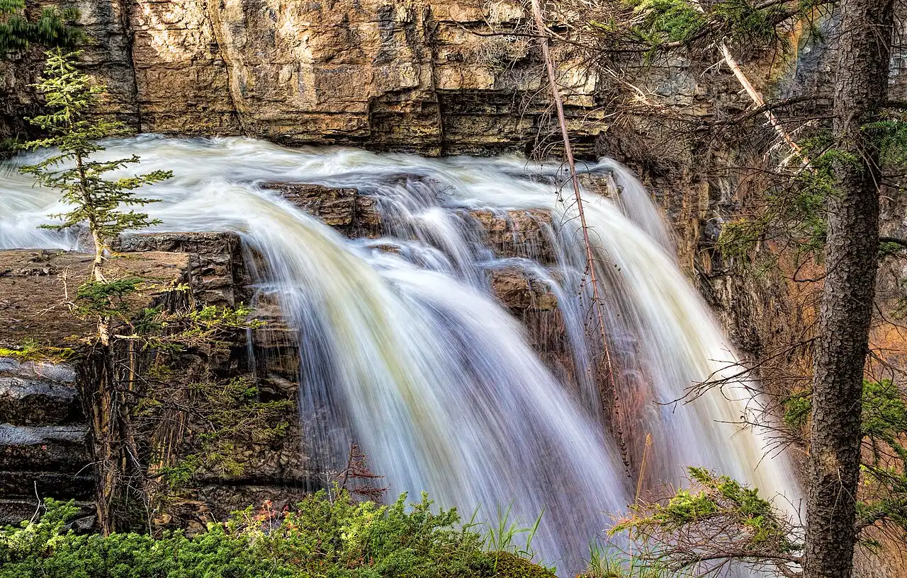 Johnston Canyon Lower Falls dropping over layered limestone into the canyon below