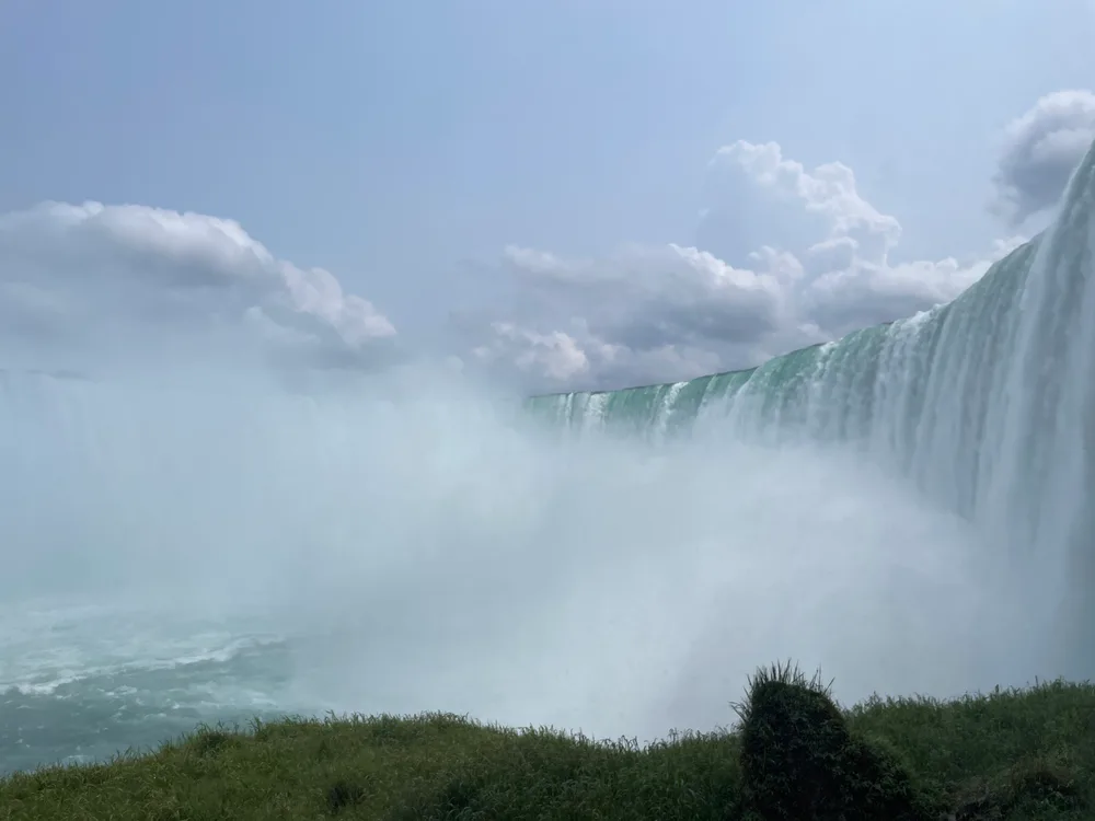 The Horseshoe Falls seen from the rim of the gorge, with mist rising over the river
