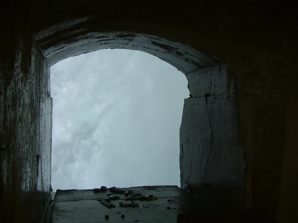 A viewing portal cut through the rock, looking out onto the curtain of falling water