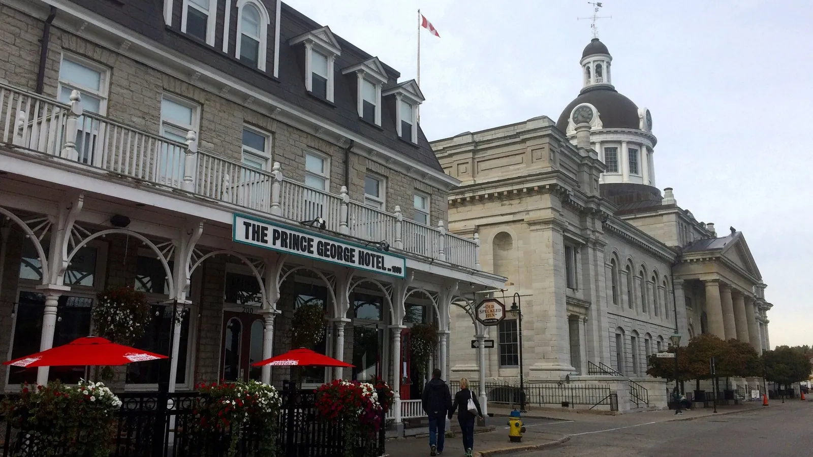 Limestone civic buildings and harbour edge in downtown Kingston under a clear sky