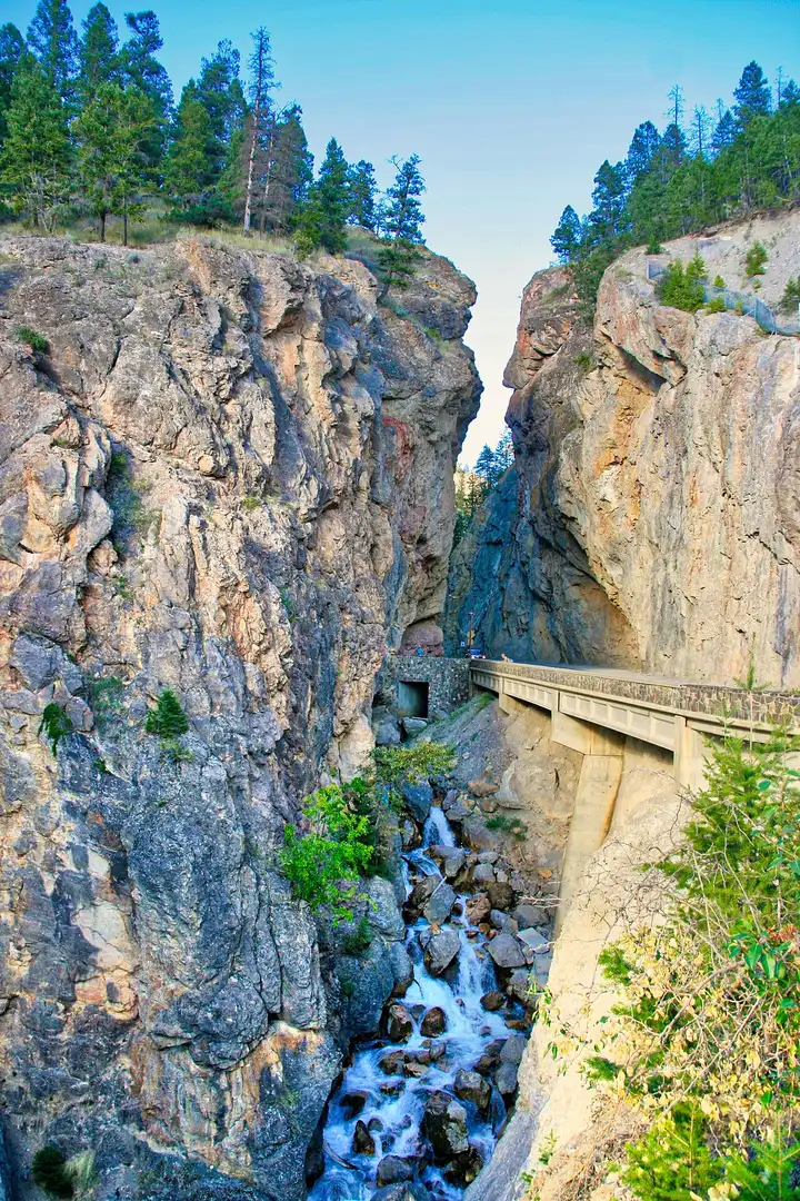 Highway 93 passing through the narrow red rock gates of Sinclair Canyon at Radium Hot Springs