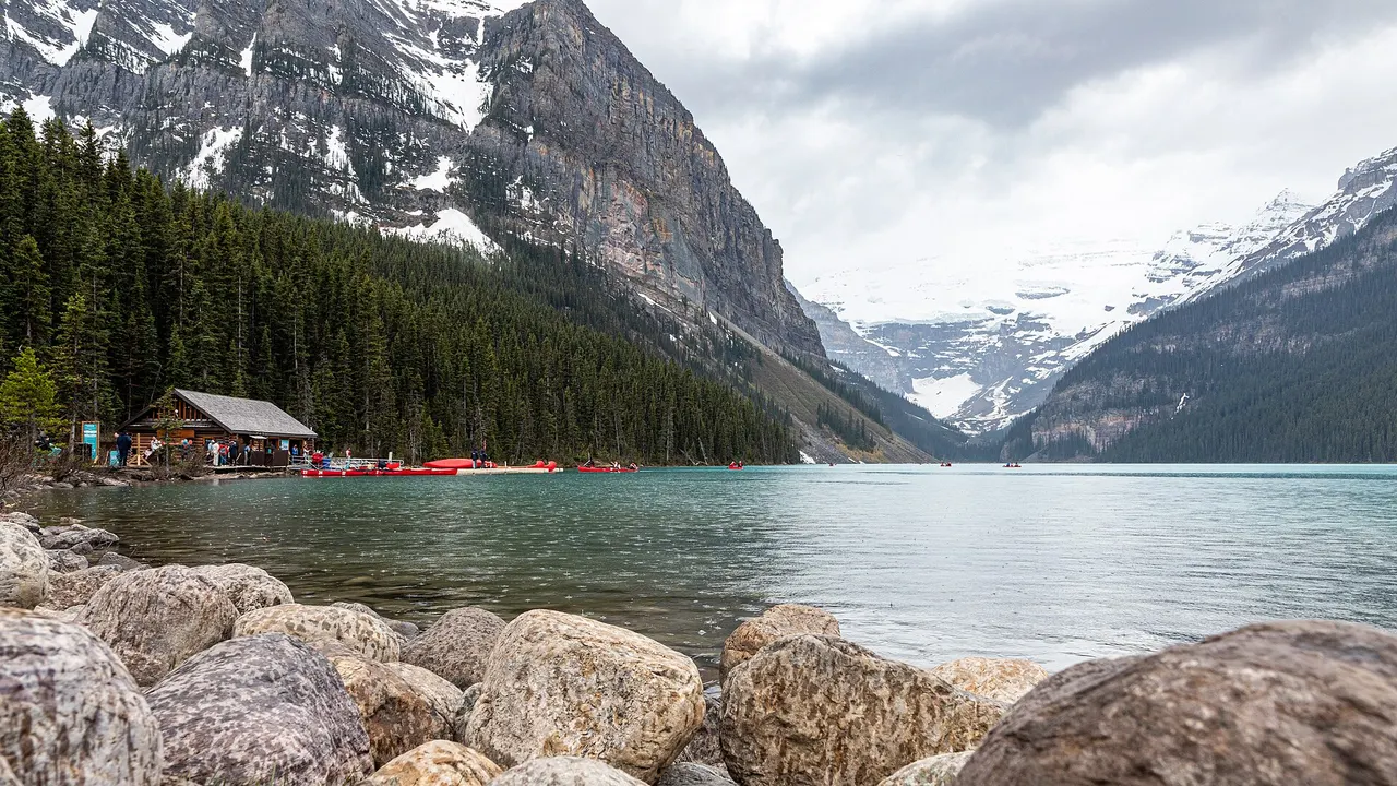 Turquoise Lake Louise filling the valley below forested slopes and the Victoria Glacier