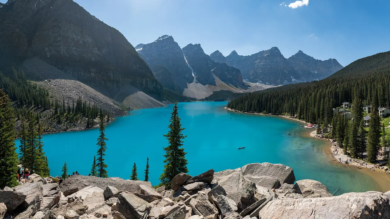 Moraine Lake and the Valley of the Ten Peaks with a pile of pale logs along the near shore