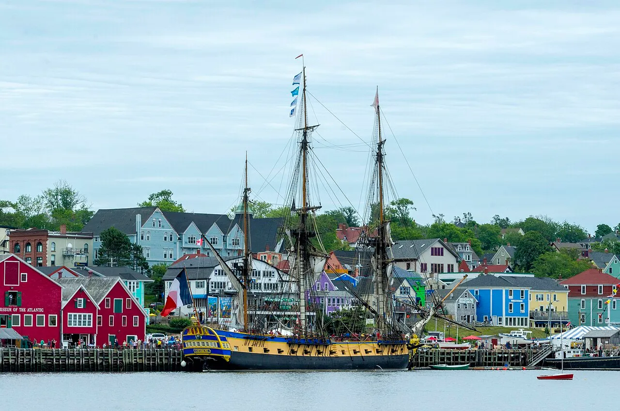 French frigate Hermione visiting Lunenburg harbour beside the waterfront buildings