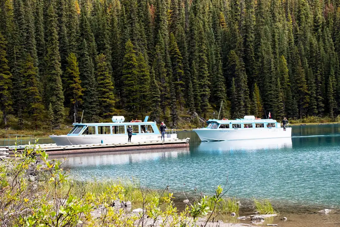 Maligne Lake Cruise tour boats near Spirit Island with mountains behind