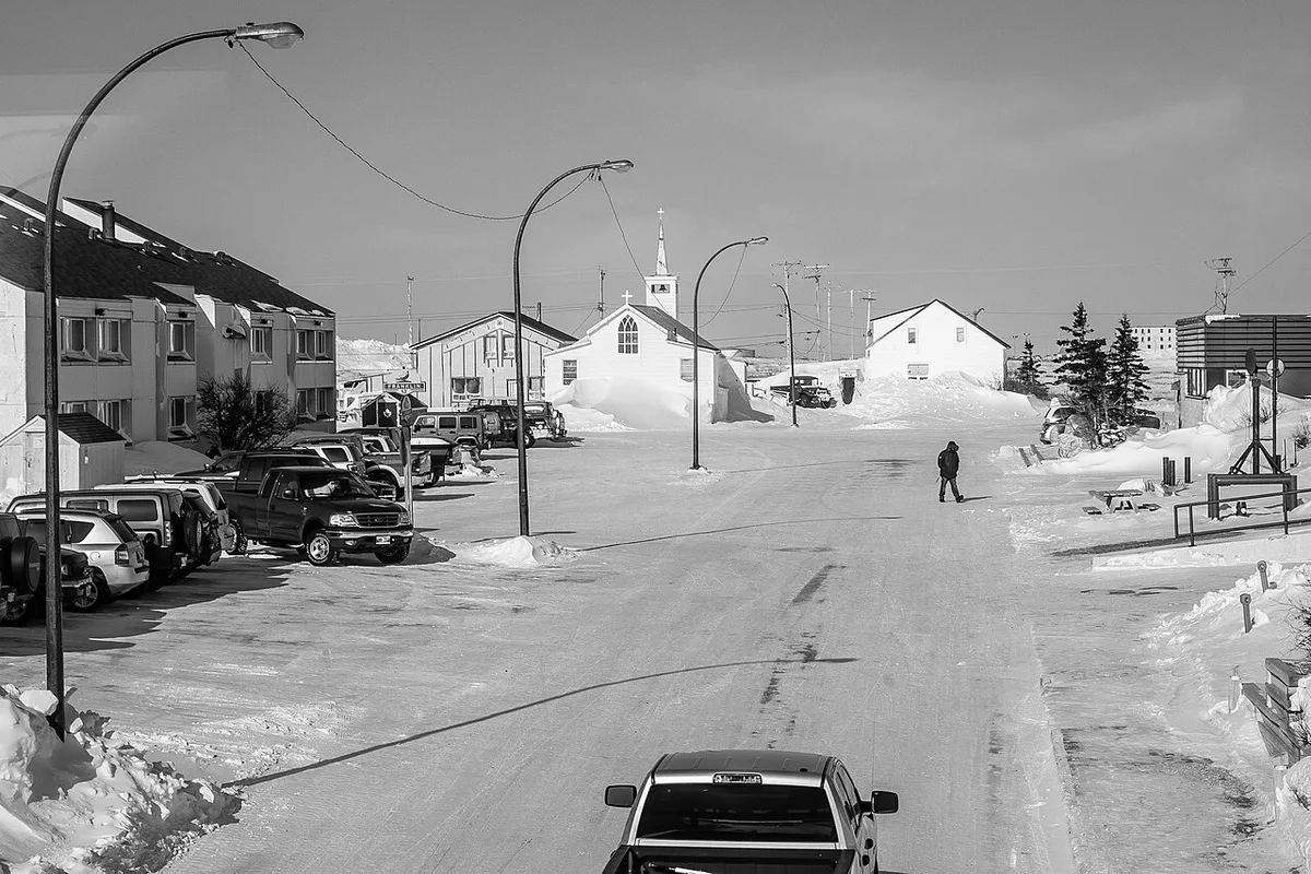 The small subarctic town of Churchill spread along the flat shore of Hudson Bay under a wide sky