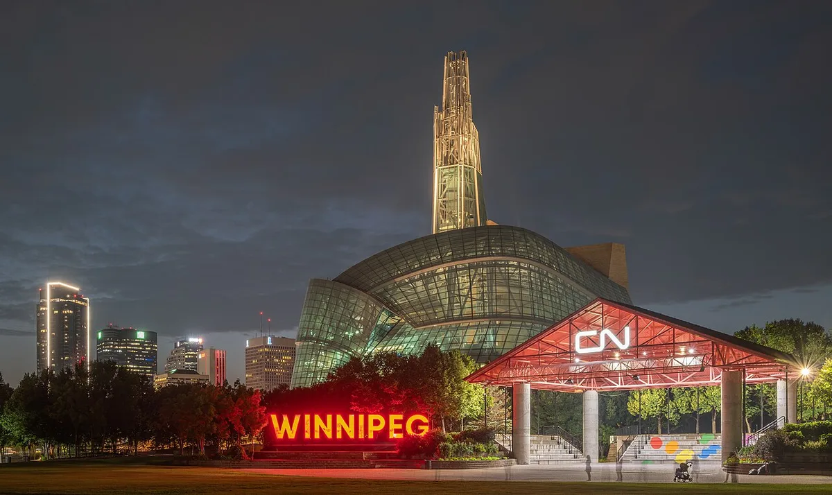 The Canadian Museum for Human Rights glowing at night with the lit Tower of Hope above the Winnipeg skyline