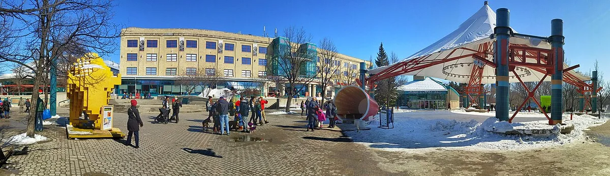 The riverfront market buildings and walkways of the Forks in Winnipeg beside the water