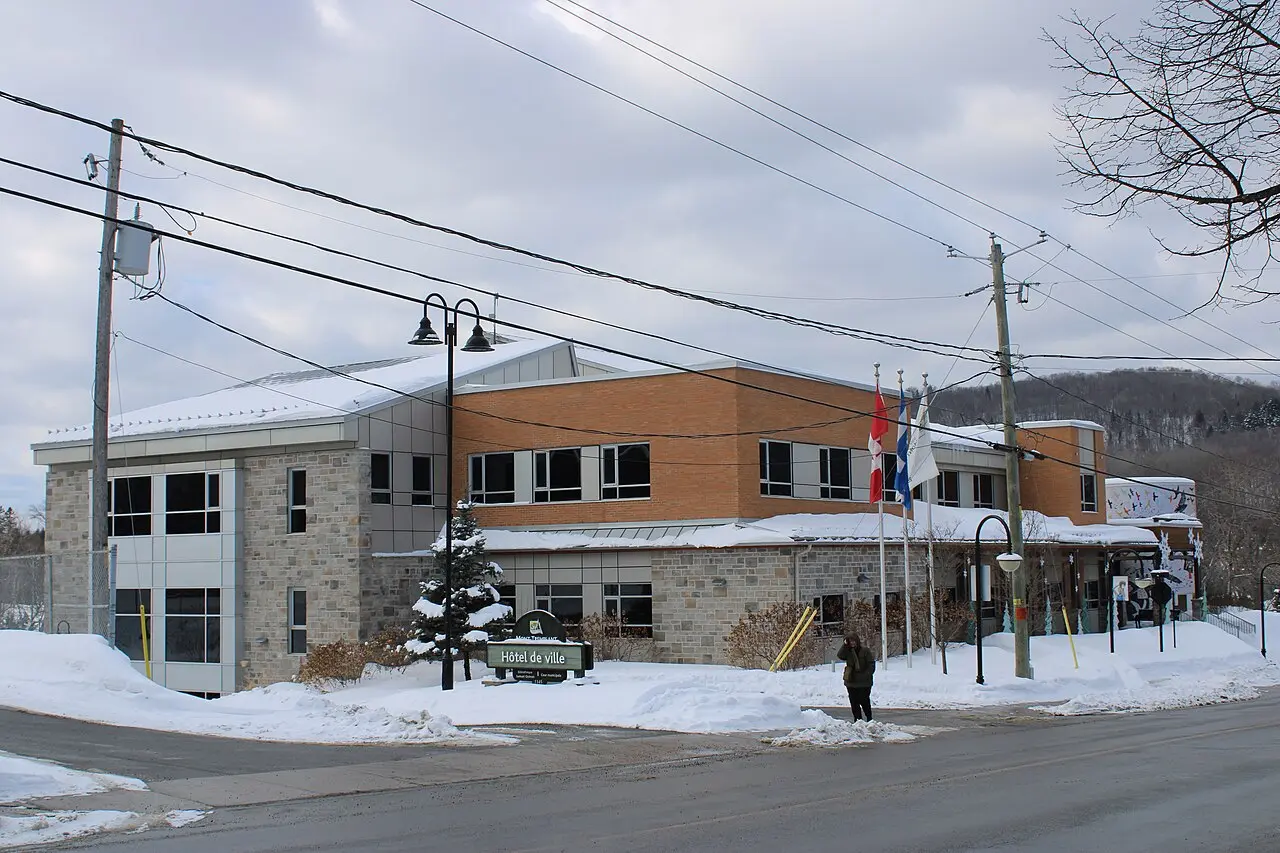 Mont-Tremblant city hall, a brick public building with a clock and a green copper roof