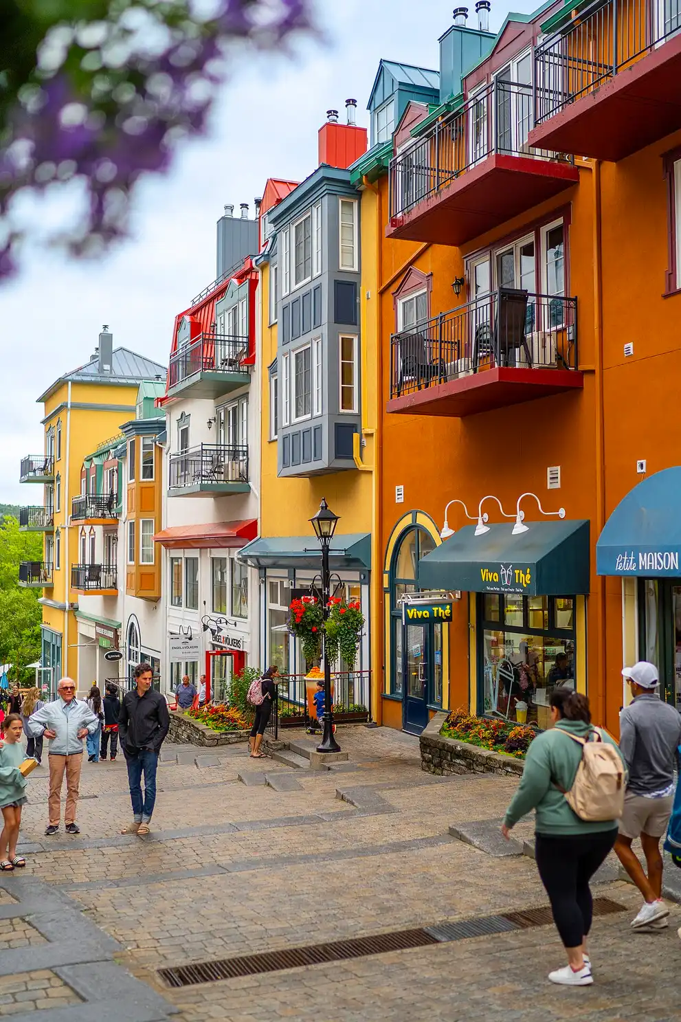 Colourful stacked buildings of the Mont-Tremblant pedestrian village climbing the slope