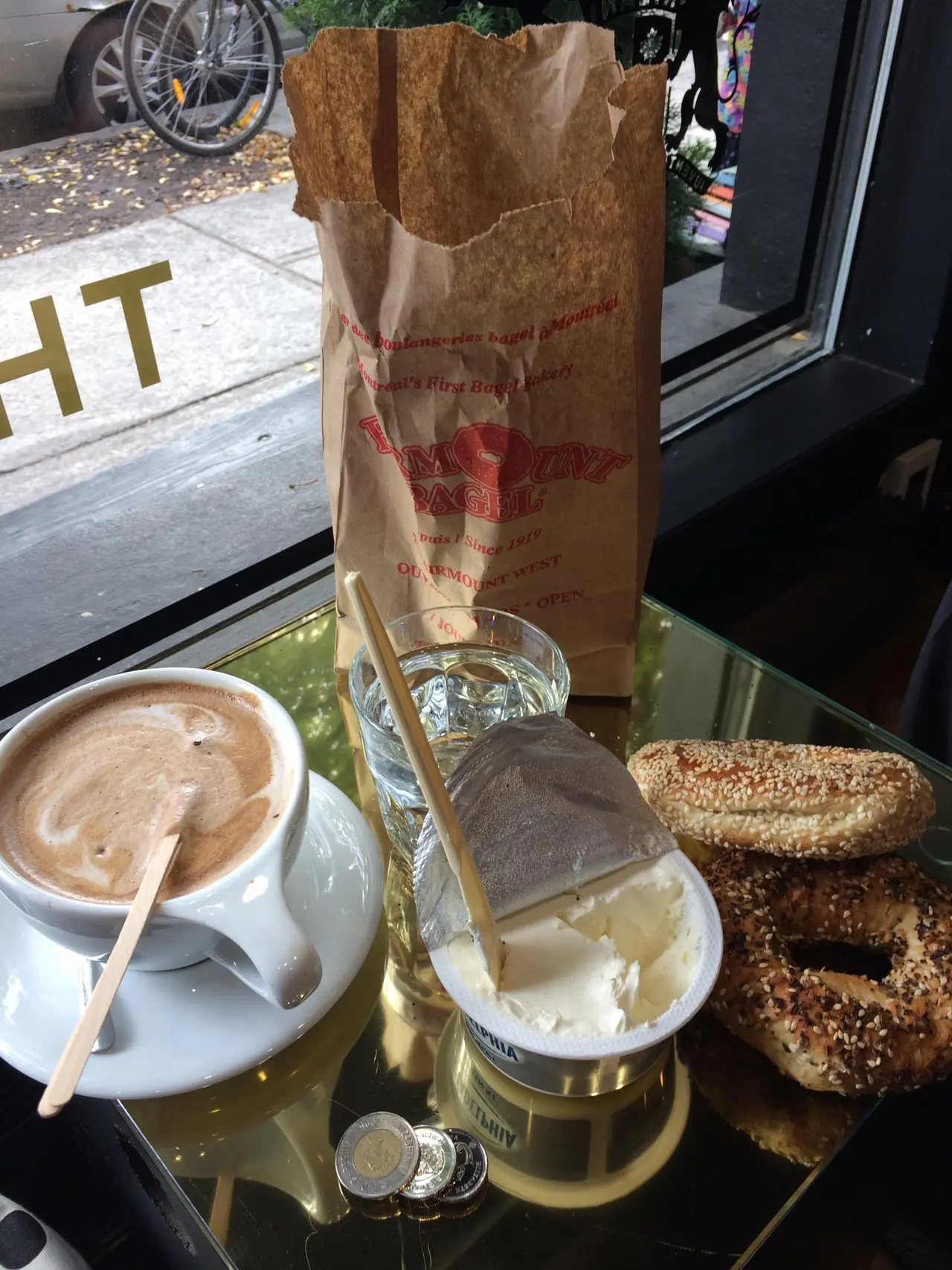 A fresh sesame Montreal bagel from Fairmount Bagel held up close